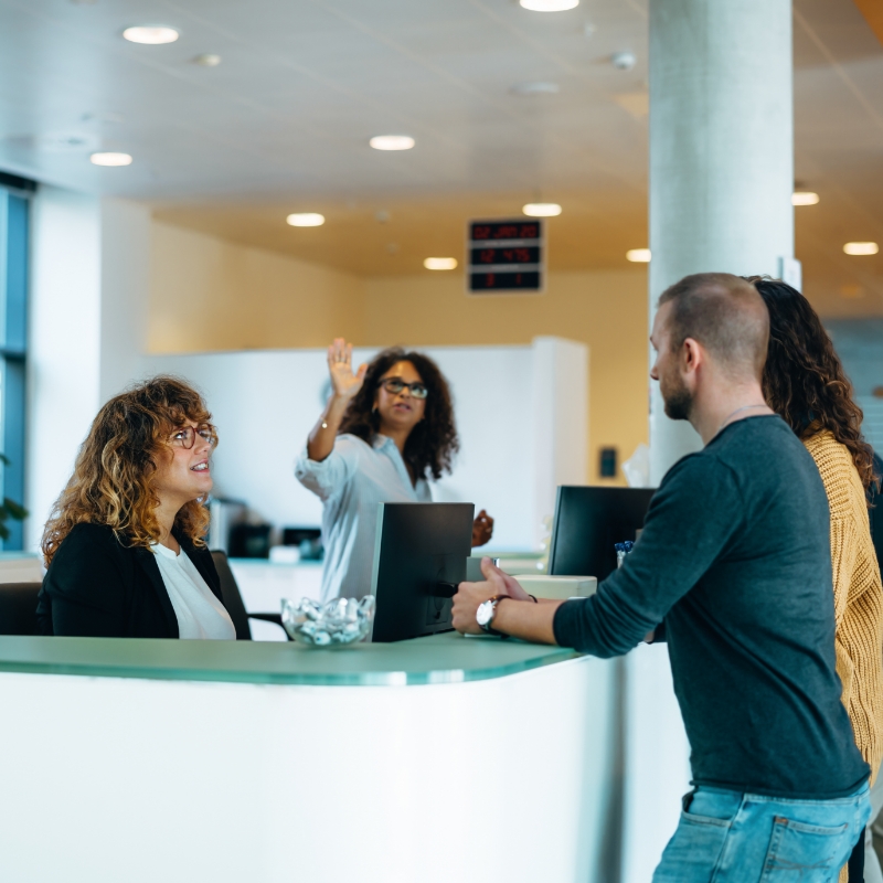 Woman in citizen's office advises young couple