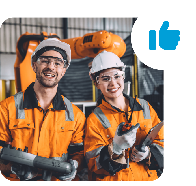 Two employees in protective clothing smile in a production hall, next to a symbol with a raised thumb.